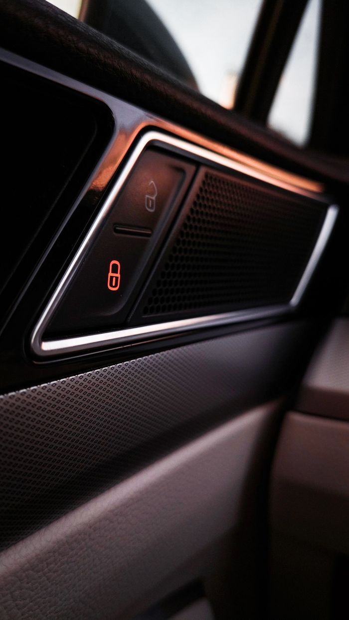 Detailed view of a modern car interior lock panel with light indicator.